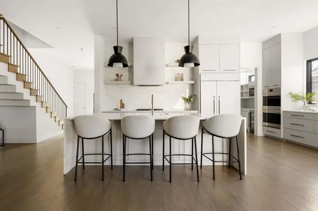 a view of dining room and kitchen with furniture wooden floor kitchen view and chairs