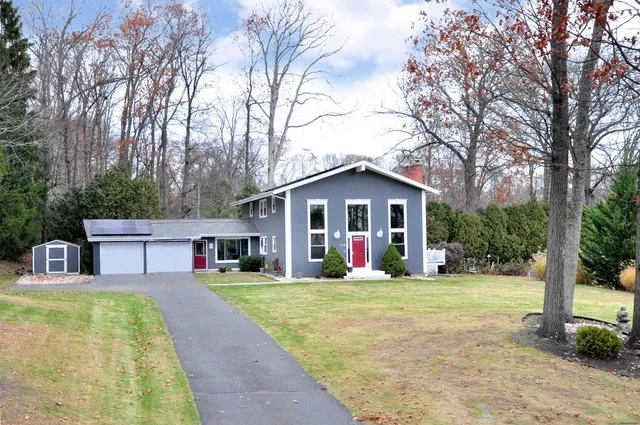 a front view of house with yard patio and green space