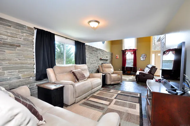 a kitchen with a dining table chairs and wooden floor