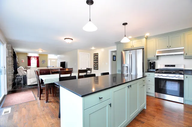 a bathroom with a sink vanity mirror and toilet