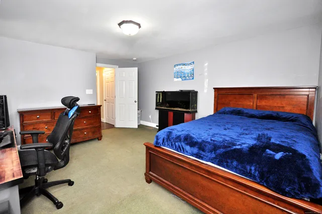 a view of bedroom with a large bed and dresser