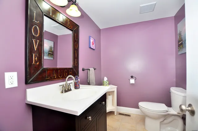 a bathroom with a sink vanity and a mirror