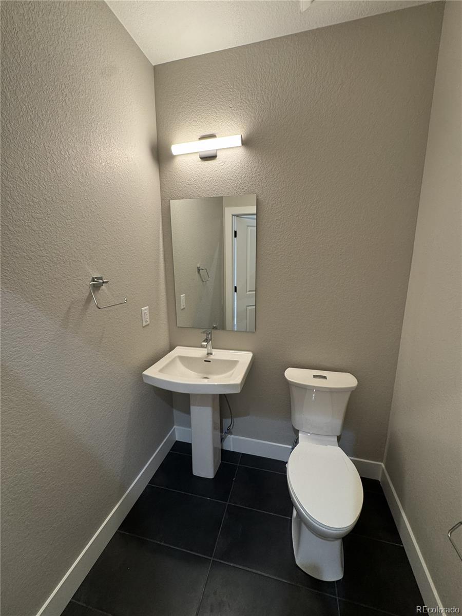 1652 Lafayette Street, Unit 6 Denver, CO 80218 - Photo 12 of 12 a bathroom with a sink toilet and a mirror