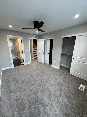 a view of an empty room with a fireplace and a window