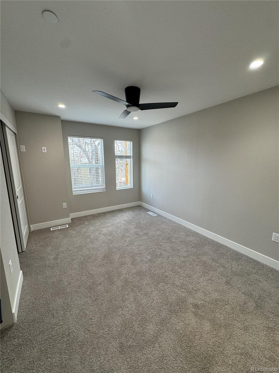 1652 Lafayette Street, Unit 6 Denver, CO 80218 - Photo 6 of 12 an empty room with windows and ceiling fan