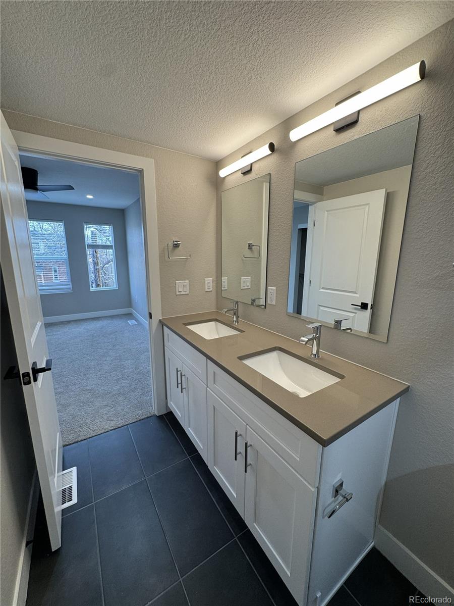 1652 Lafayette Street, Unit 6 Denver, CO 80218 - Photo 7 of 12 a bathroom with a double vanity sink and mirror