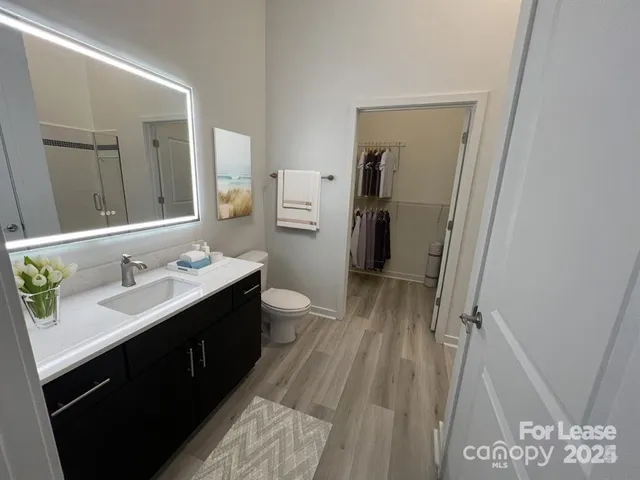 a bathroom with a double vanity sink mirror and toilet