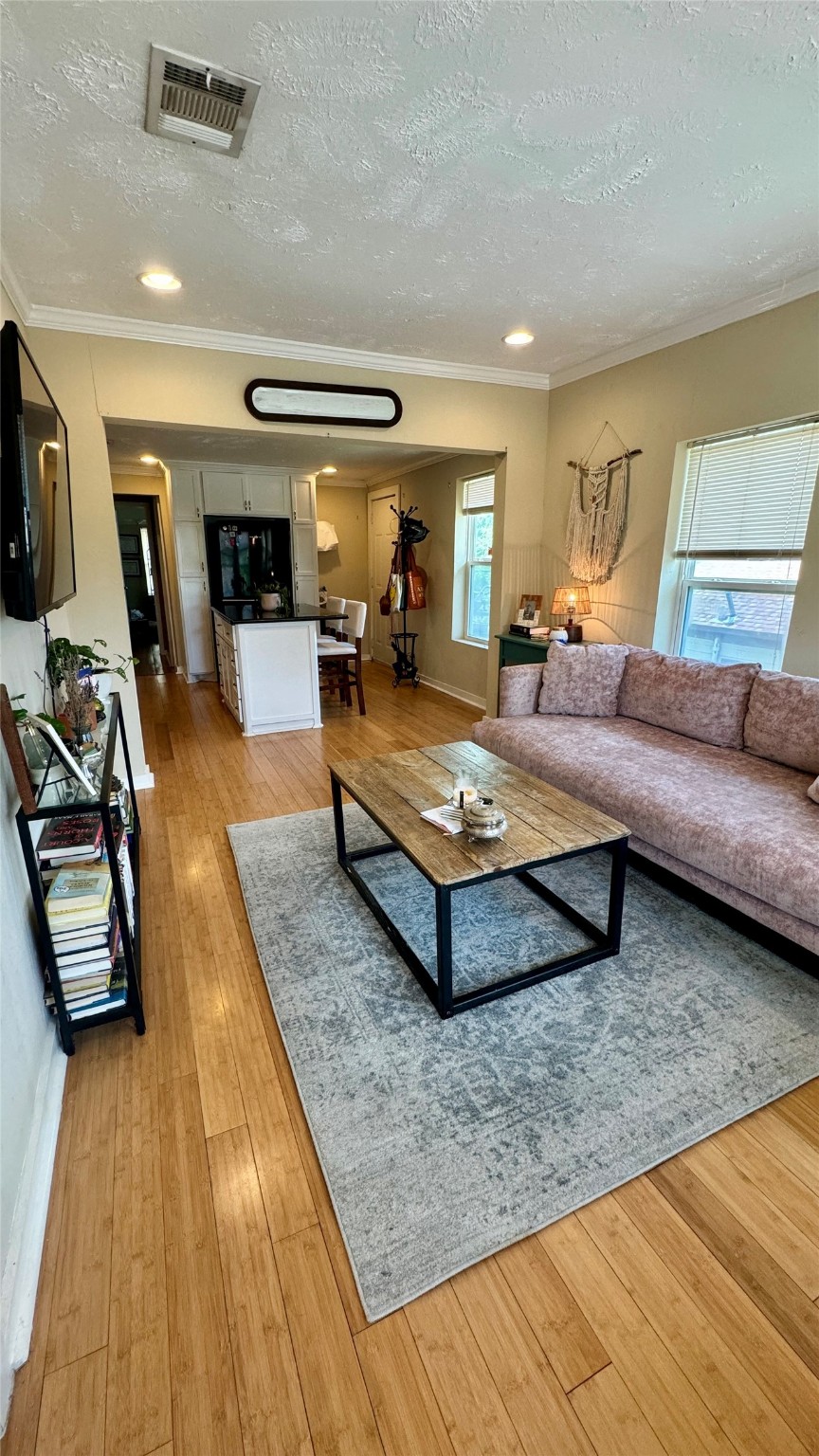 a living room with patio furniture and a wooden floor