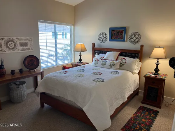 a bedroom with bed and window