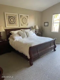 a bedroom with a bed and window