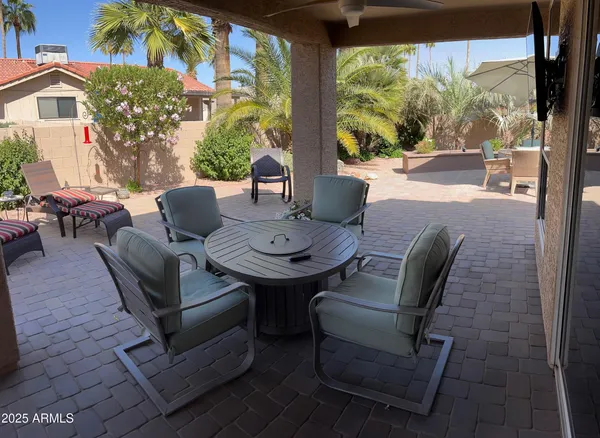 a view of a patio with table and chairs and potted plants