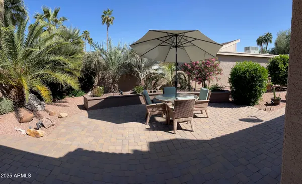 a view of a backyard with sitting area
