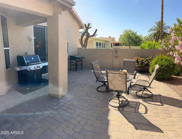 a view of a patio with table and chairs