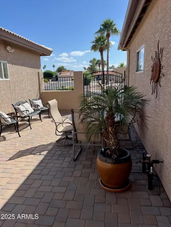 a view of a patio with chairs and potted plants