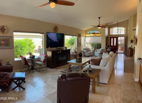 a living room with fireplace furniture and a flat screen tv