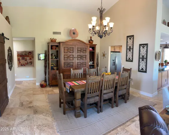 a view of a dining room with furniture and chandelier