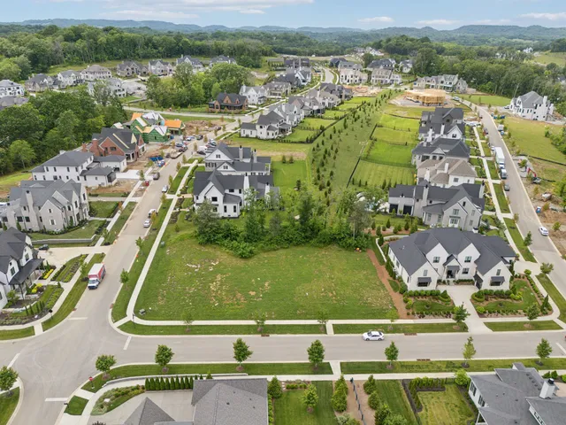 an aerial view of a residential houses with outdoor space