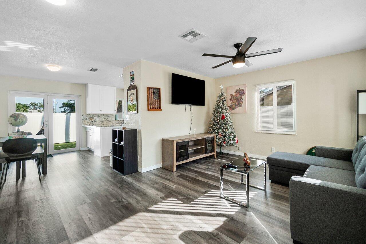 119 Southeast 5th Street Delray Beach, FL 33483 - Photo 13 of 27 a living room with furniture a fireplace and a flat screen tv
