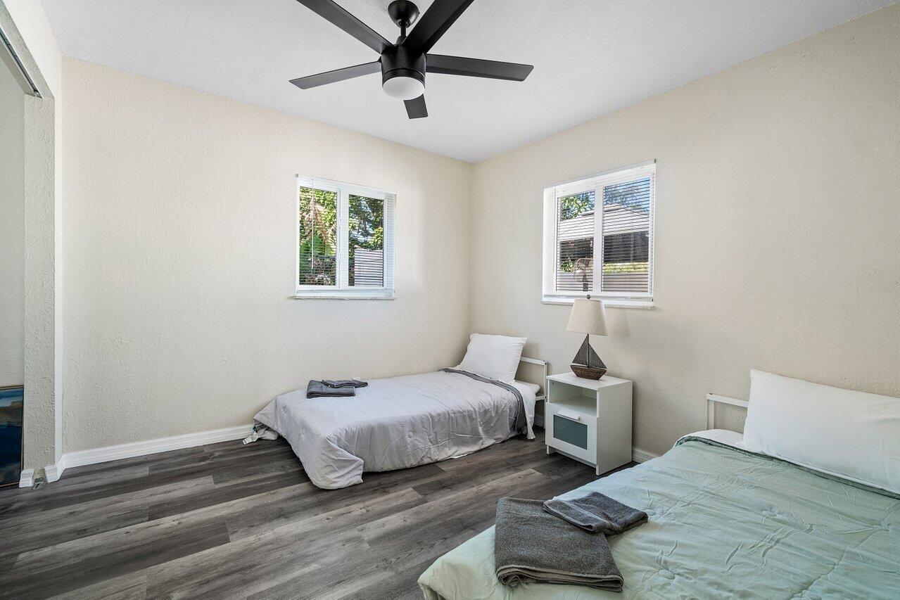 119 Southeast 5th Street Delray Beach, FL 33483 - Photo 25 of 27 a bedroom with a bed and wooden floor