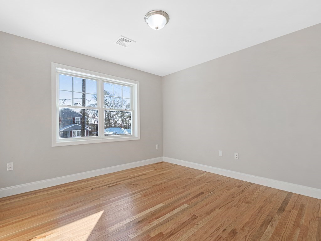 33 Circle Drive Waltham, MA 02452 - Photo 20 of 38 wooden floor in an empty room with a window