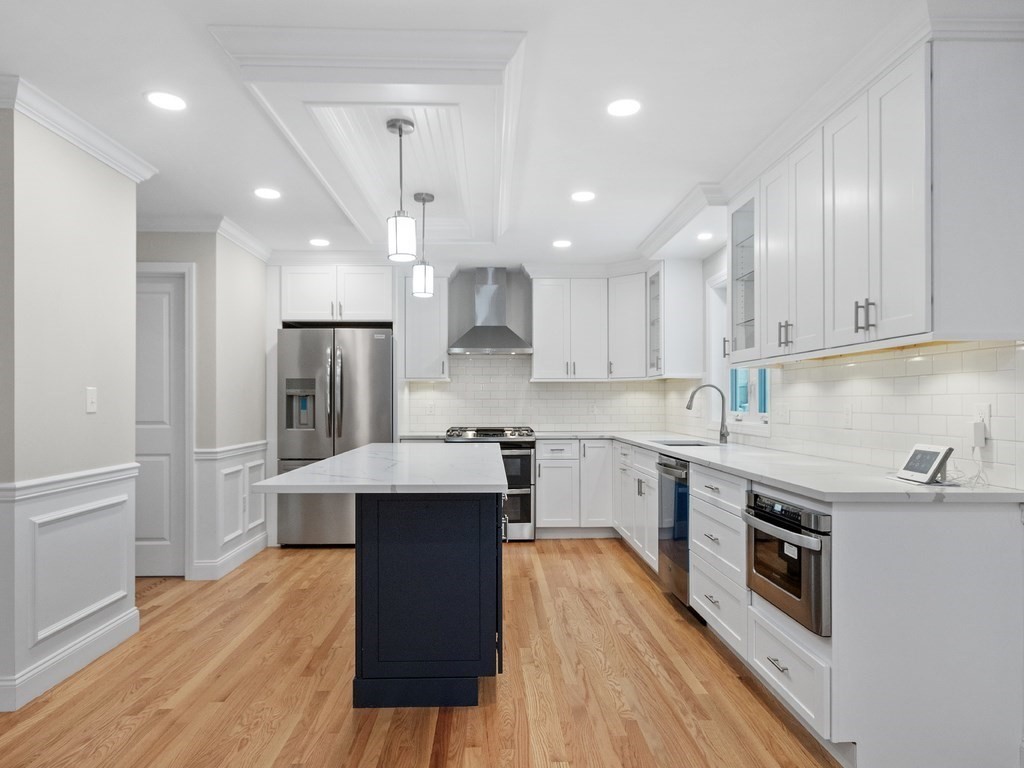 33 Circle Drive Waltham, MA 02452 - Photo 5 of 38 a kitchen with stainless steel appliances a sink dishwasher a refrigerator a stove top oven and wooden floor