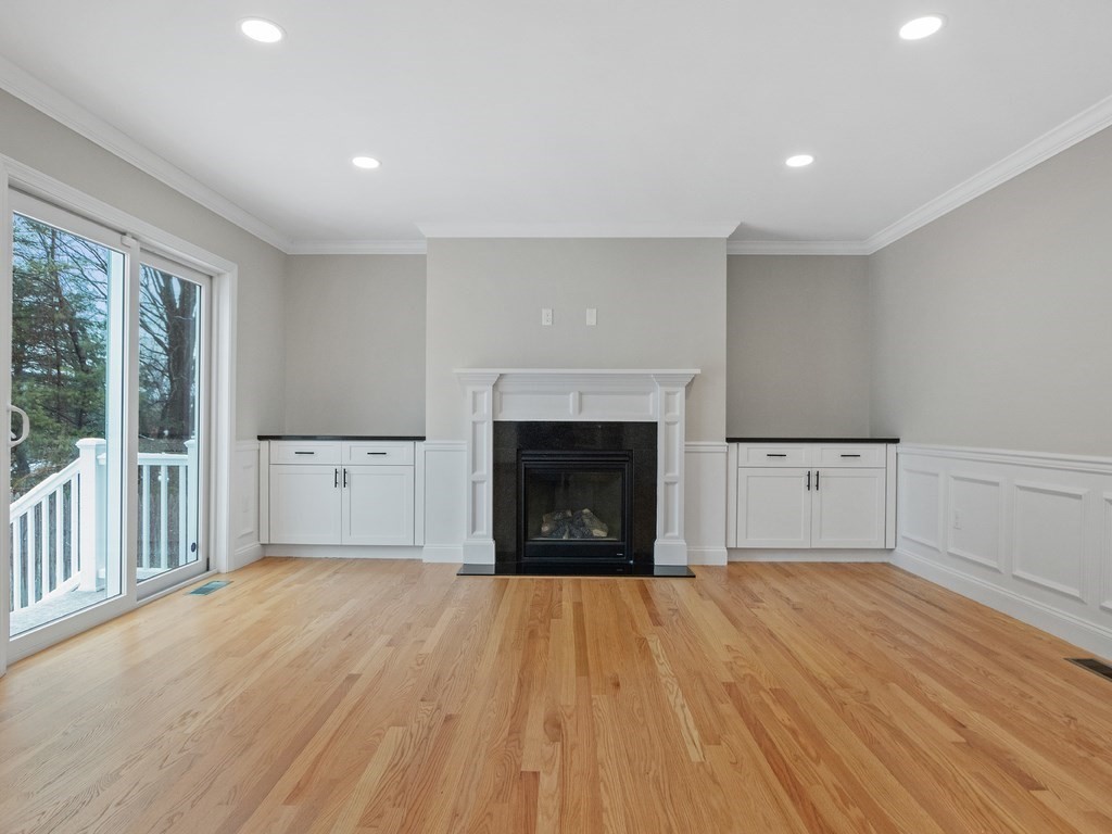 33 Circle Drive Waltham, MA 02452 - Photo 10 of 38 a view of a livingroom with wooden floor and a fireplace