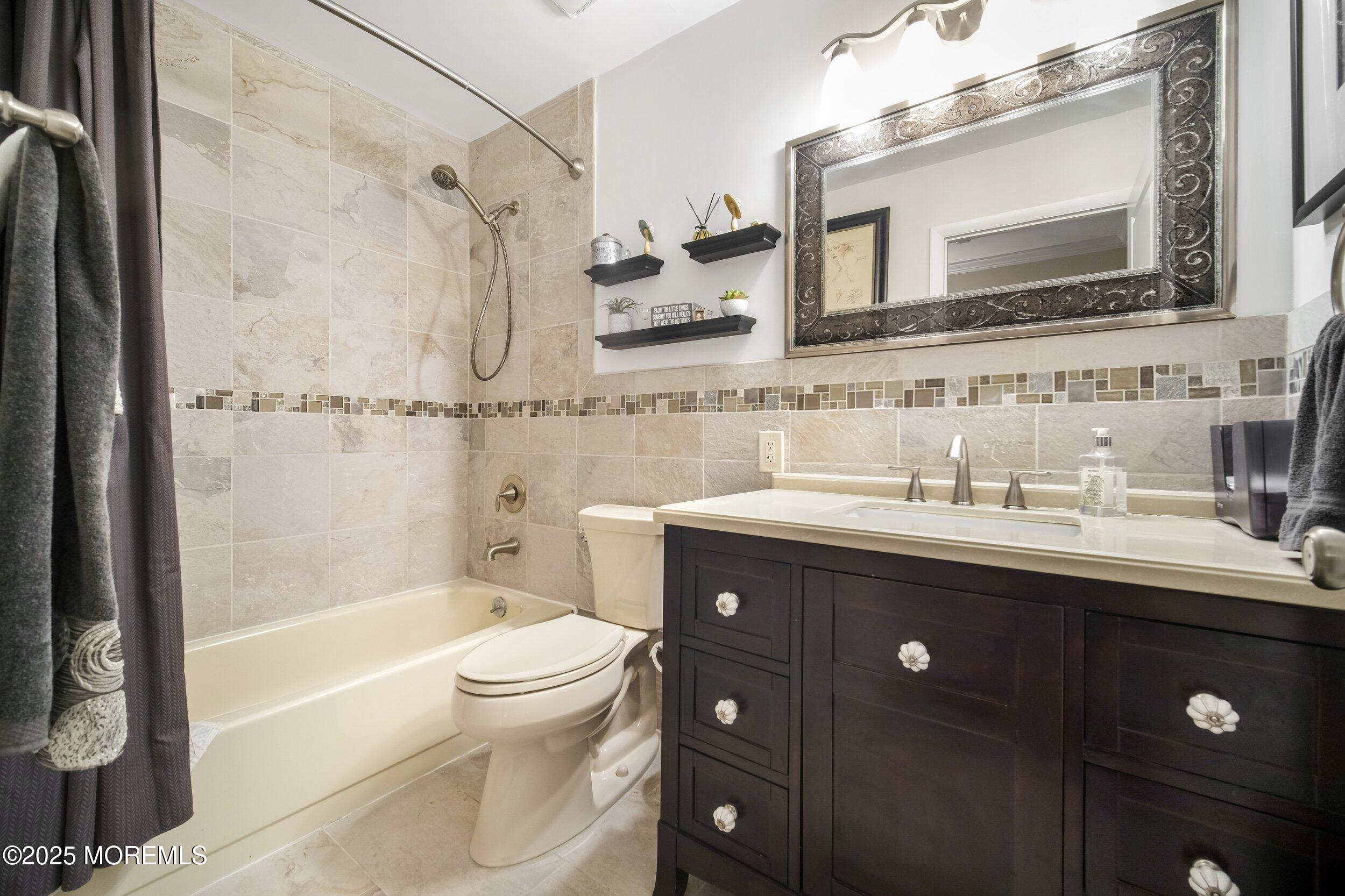 17 B Drake Street Whiting, NJ 08759 - Photo 17 of 18 a bathroom with a bathtub shower sink vanity mirror and toilet