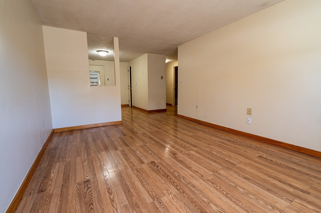 234 Low Street, Unit 3 Newburyport, MA 01950 - Photo 3 of 13 a view of an empty room with wooden floor