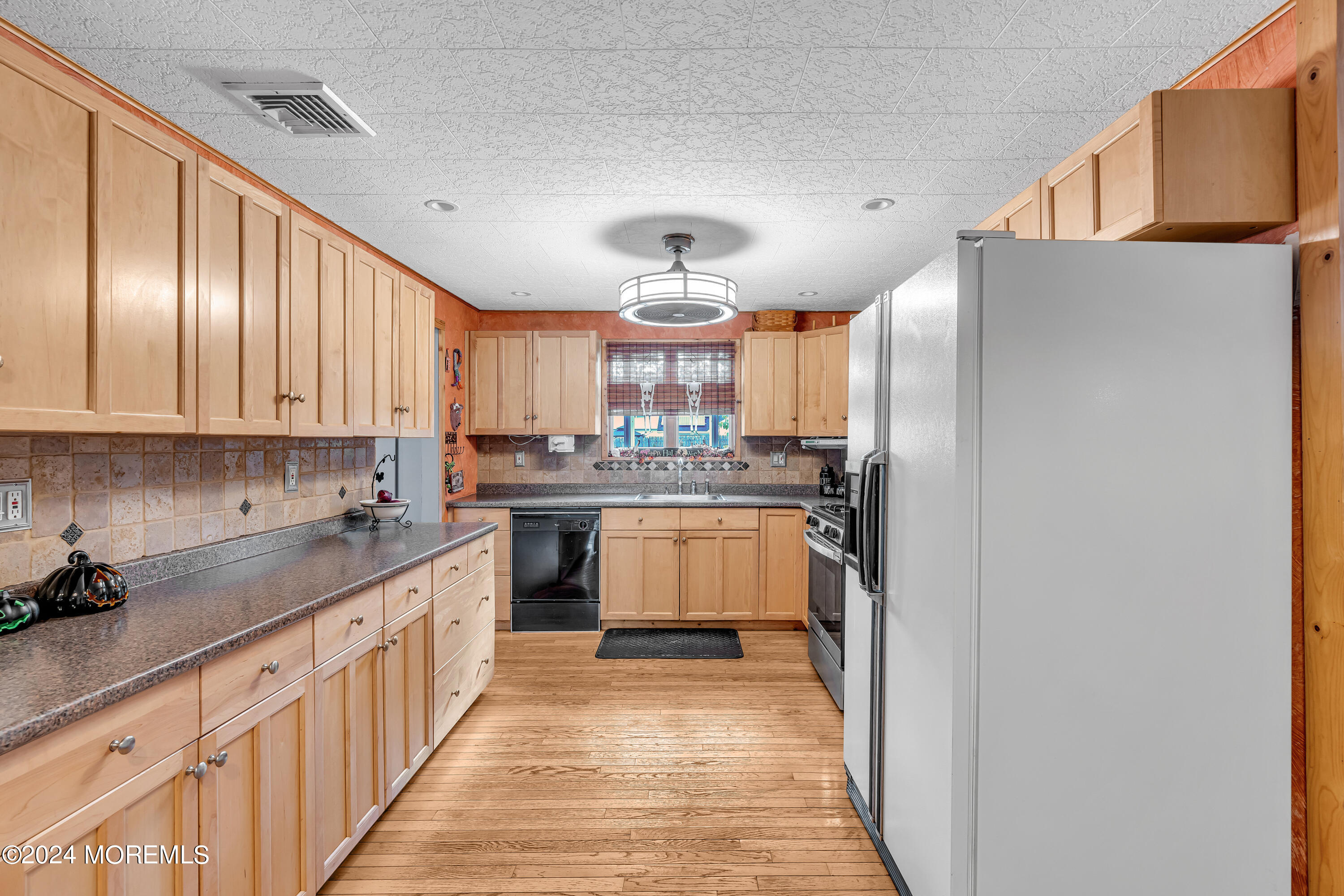 13 Hemlock Road Howell, NJ 07731 - Photo 14 of 48 a kitchen with stainless steel appliances granite countertop a refrigerator and a stove top oven