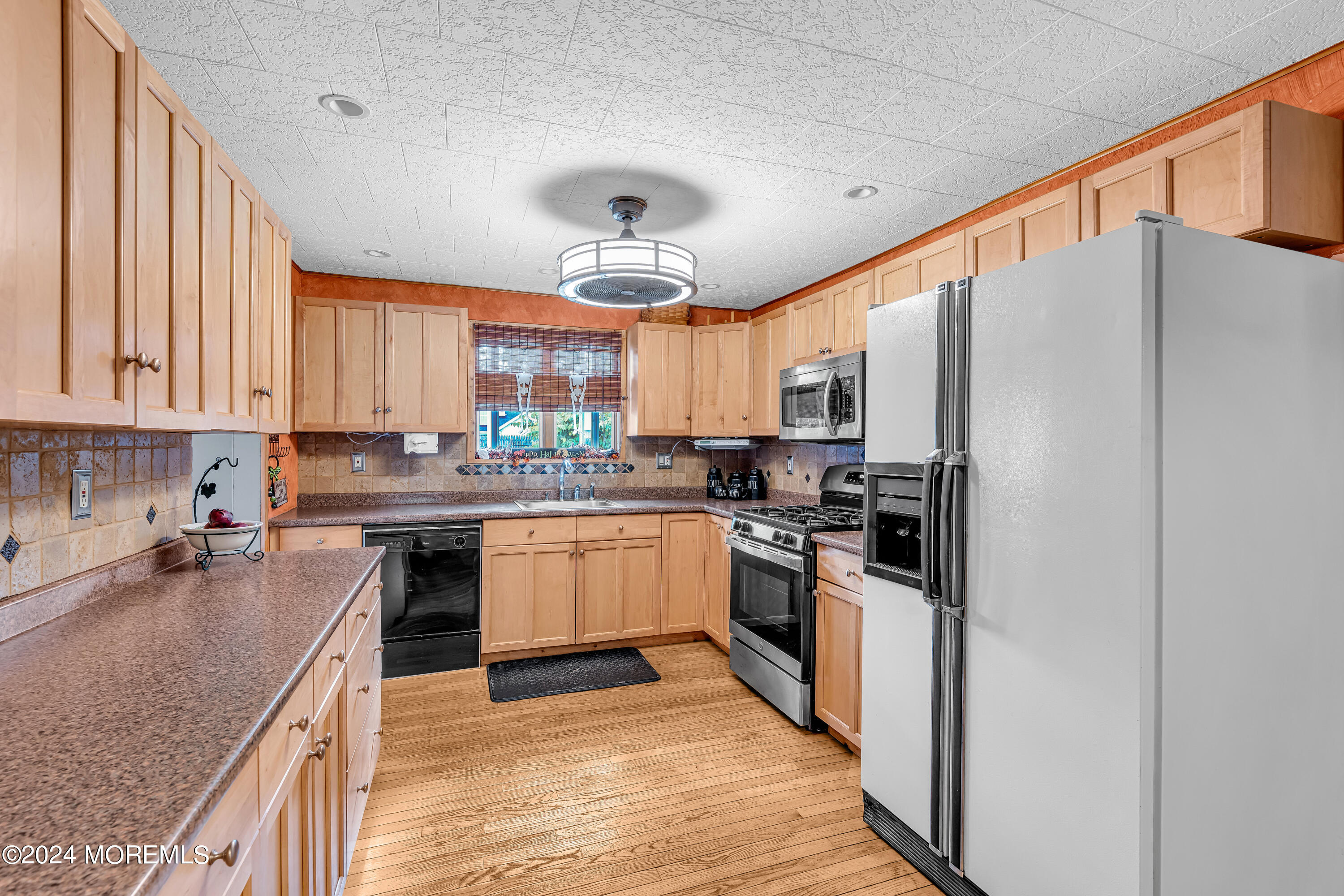 13 Hemlock Road Howell, NJ 07731 - Photo 16 of 48 a kitchen with stainless steel appliances granite countertop a stove refrigerator sink and cabinets