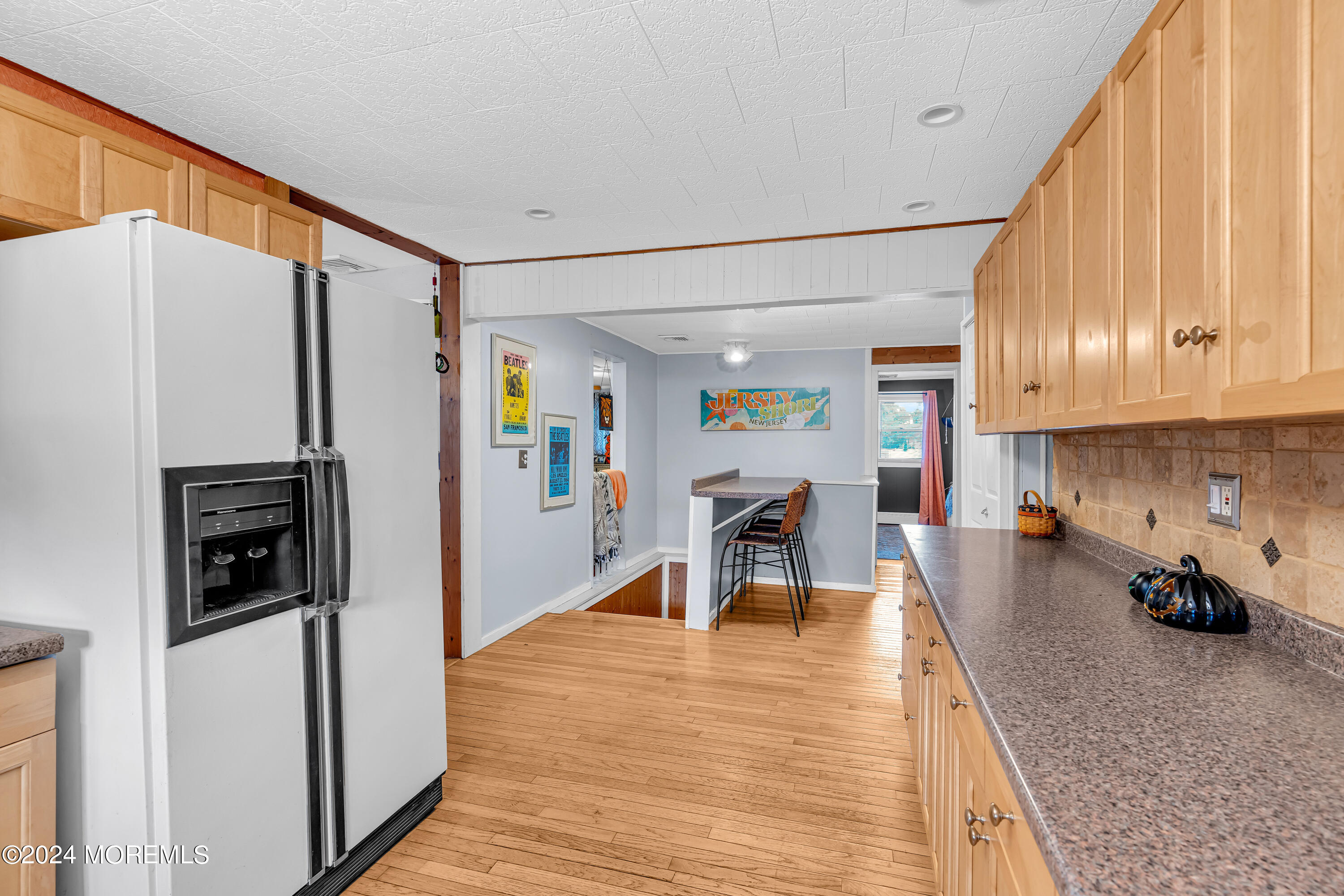 13 Hemlock Road Howell, NJ 07731 - Photo 18 of 48 a kitchen with stainless steel appliances granite countertop a refrigerator a stove a sink dishwasher and white cabinets with wooden floor
