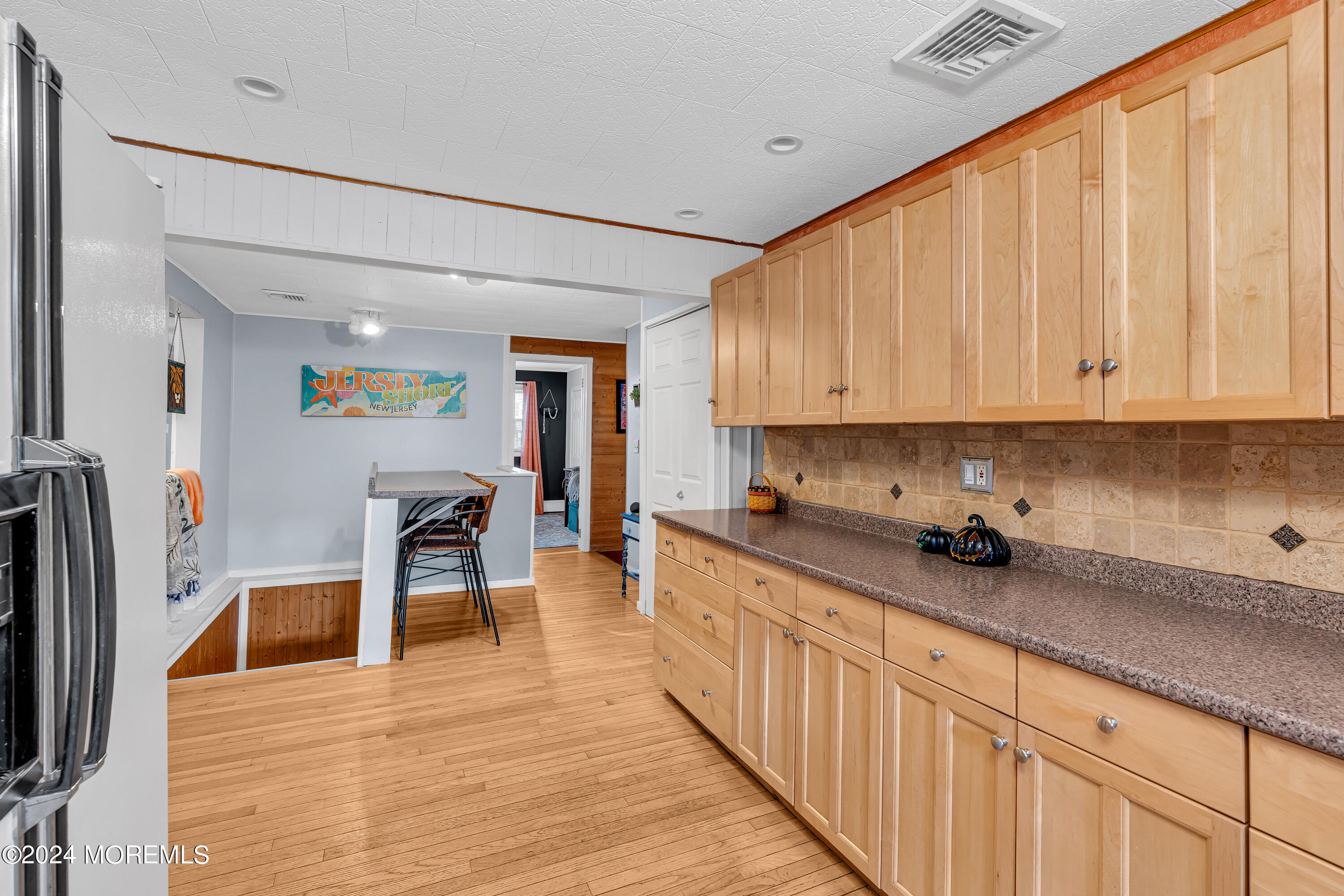 13 Hemlock Road Howell, NJ 07731 - Photo 19 of 48 a kitchen with stainless steel appliances a microwave a stove a sink dishwasher and cabinets with wooden floor