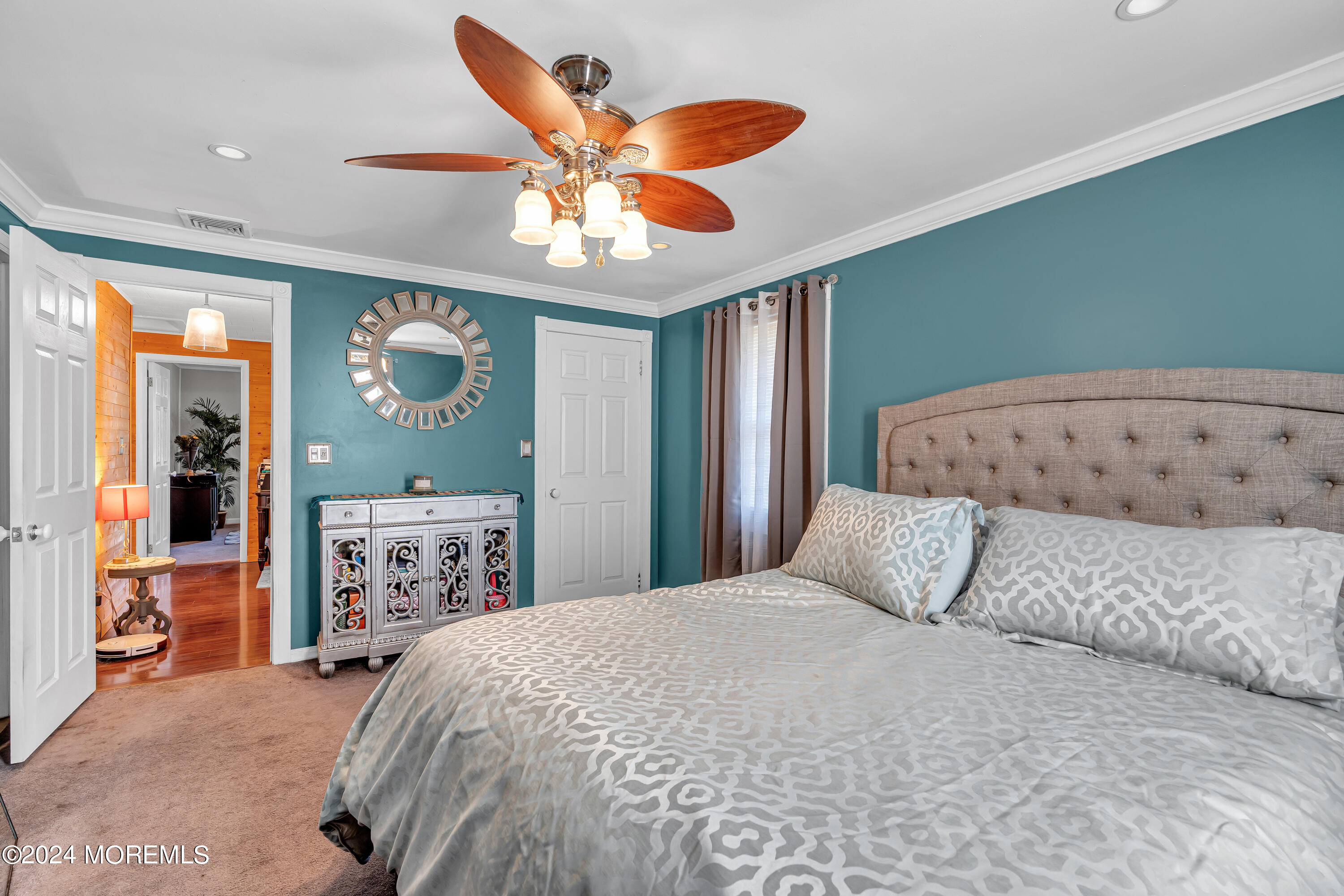 13 Hemlock Road Howell, NJ 07731 - Photo 29 of 48 a bedroom with a large bed and a chandelier