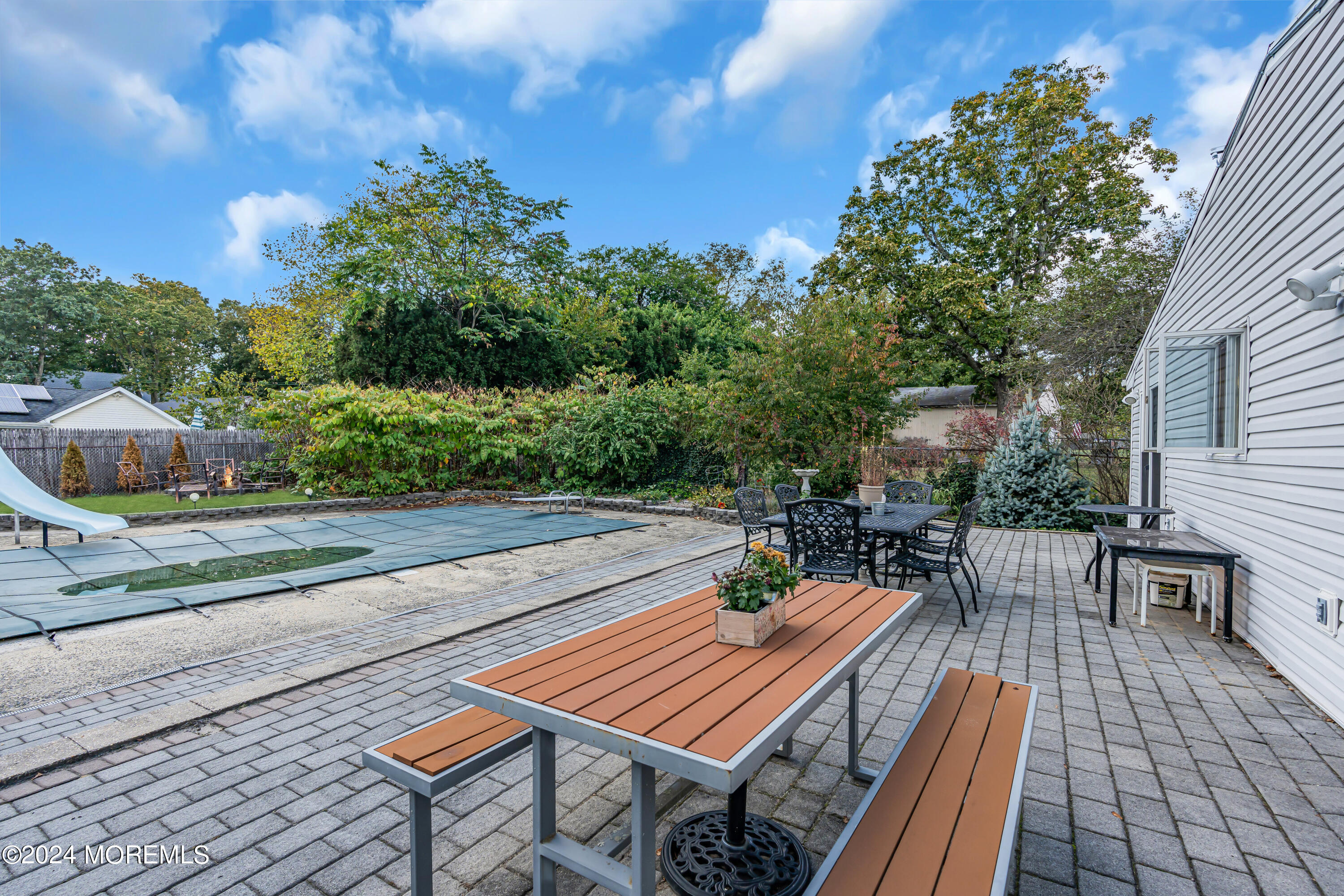 13 Hemlock Road Howell, NJ 07731 - Photo 37 of 48 a view of a patio with dining table and chairs with wooden floor and fence