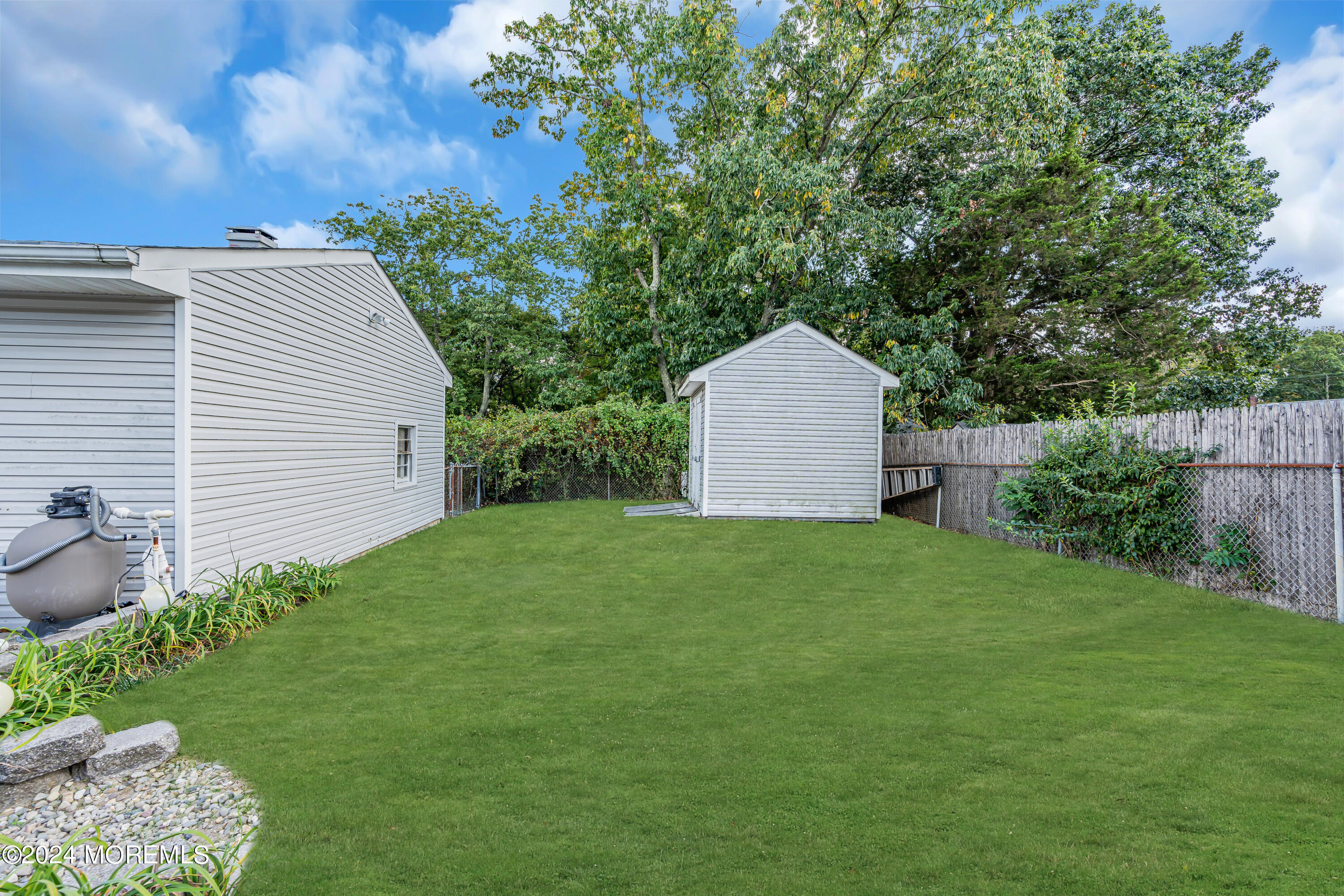 13 Hemlock Road Howell, NJ 07731 - Photo 42 of 48 a backyard of a house with plants and outdoor seating