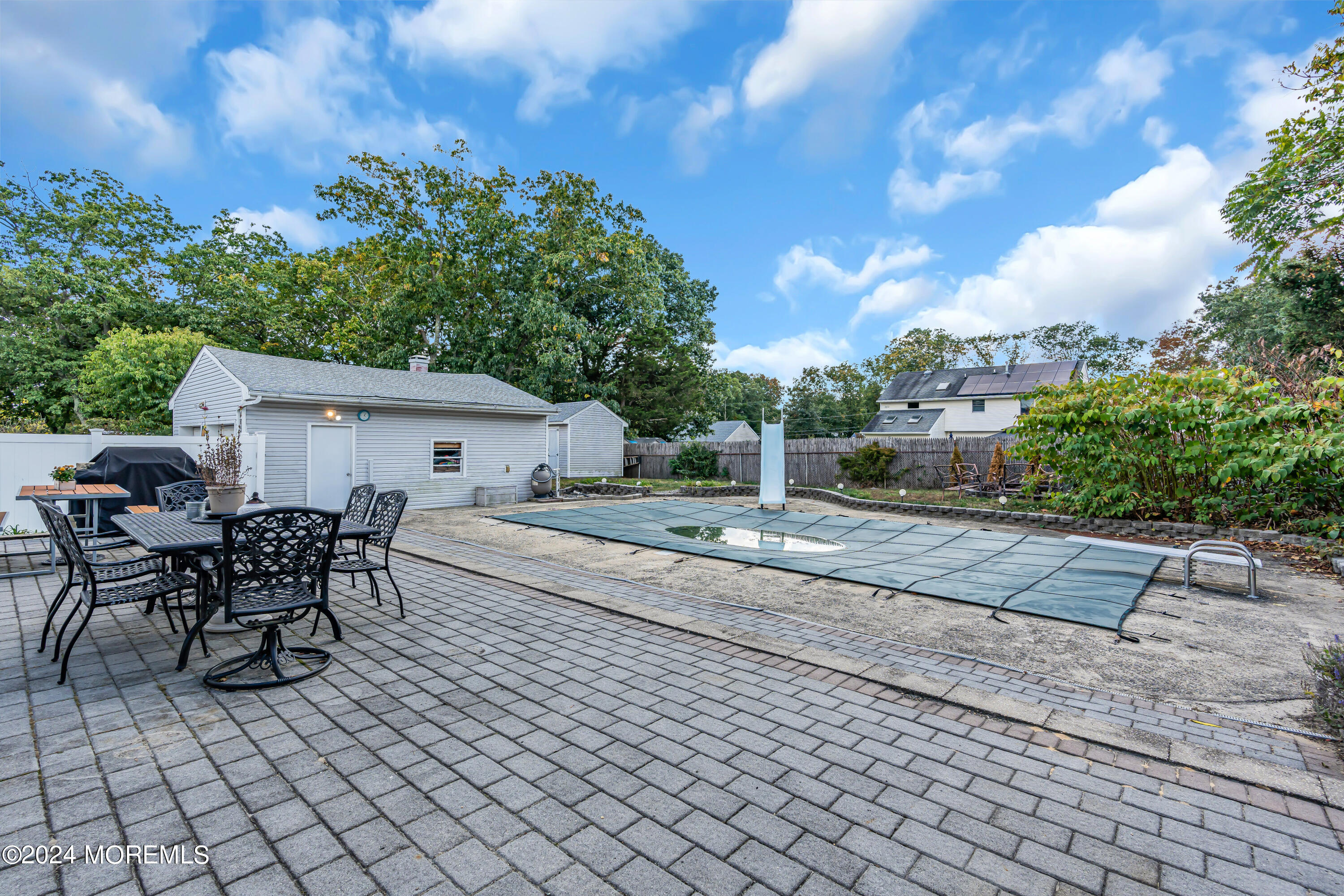 13 Hemlock Road Howell, NJ 07731 - Photo 45 of 48 a view of a patio with table and chairs and potted plants
