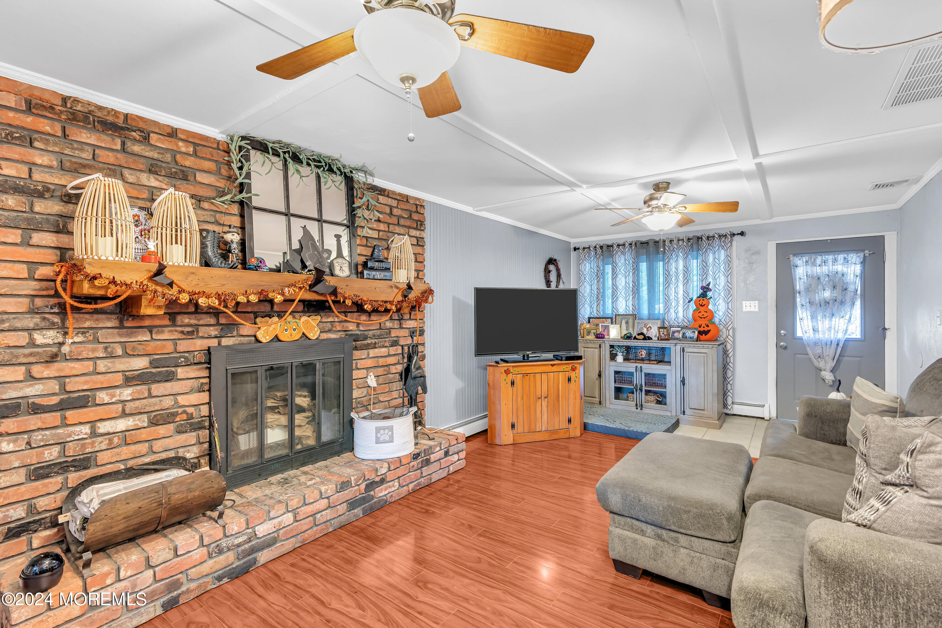 13 Hemlock Road Howell, NJ 07731 - Photo 9 of 48 a living room with furniture a fireplace and a flat screen tv