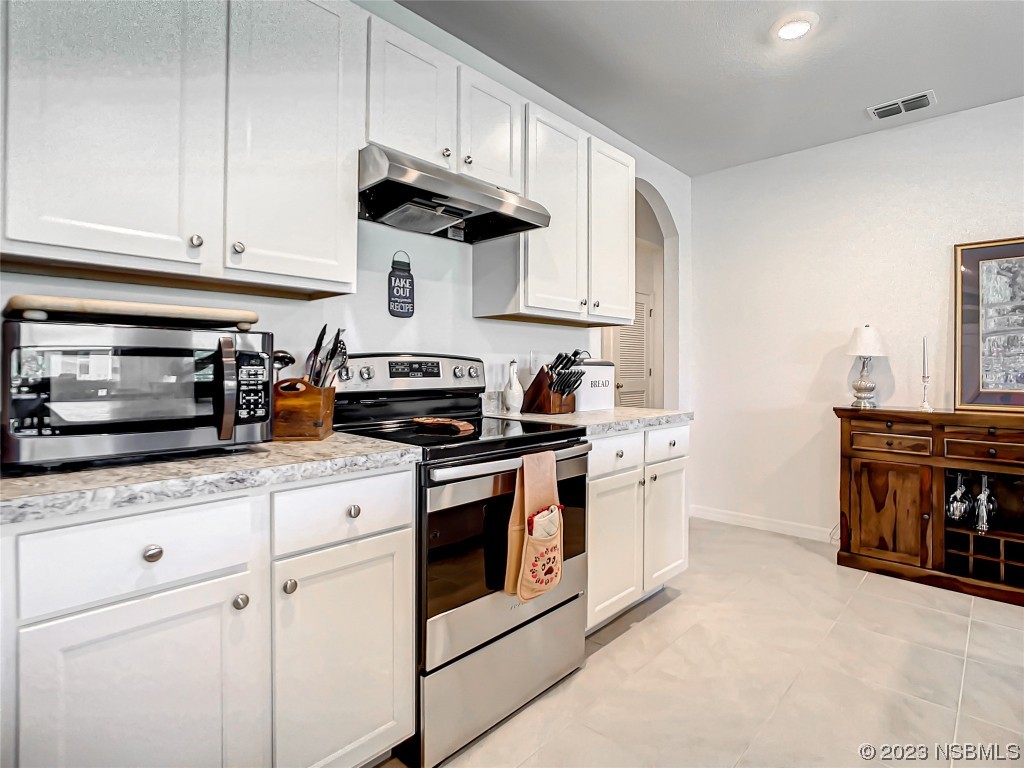 126 Old Mill Edgewater, FL 32141 - Photo 9 of 50 a kitchen with stainless steel appliances granite countertop white cabinets sink and stove