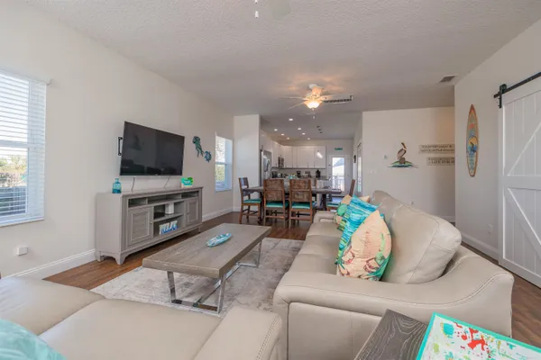 a living room with furniture and wooden floor