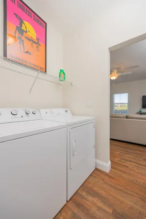 a living room with furniture a flat screen tv and kitchen view