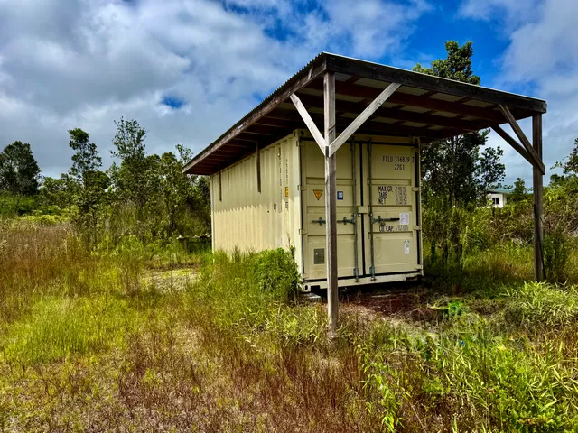 a view of a small house with a small yard