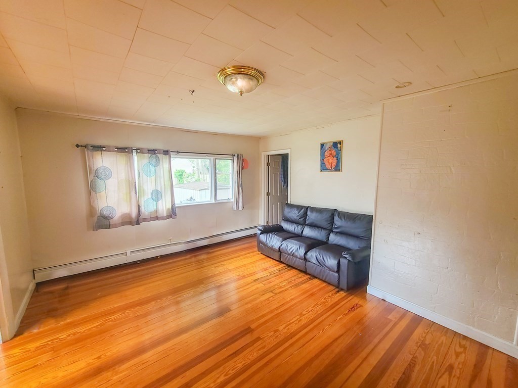 153 Field Street Fall River, MA 02721 - Photo 5 of 9 a living room with furniture and a large window