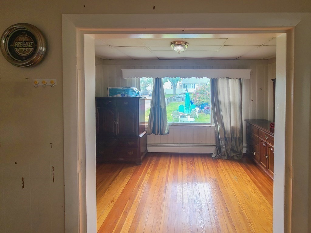 153 Field Street Fall River, MA 02721 - Photo 6 of 9 a view of empty room with wooden floor and fan