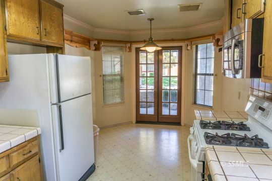 241 West Yellowstone Place Ridgecrest, CA 93555 - Photo 13 of 31 a kitchen with stainless steel appliances granite countertop a refrigerator and a stove