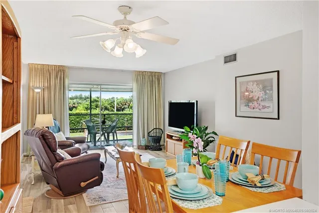 a living room with furniture a table and a large window