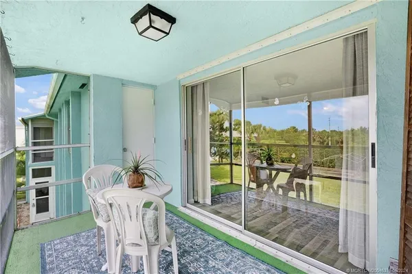 a view of a chairs and table in patio