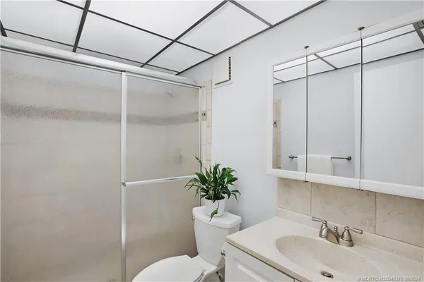 a living room with furniture and painting on the wall