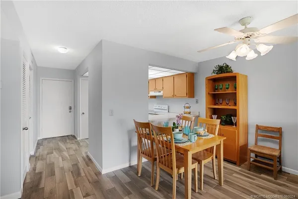 a living room with furniture a flat screen tv and a large window