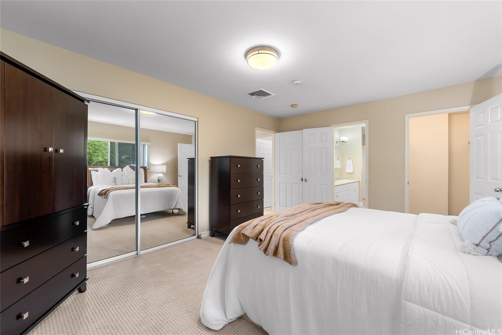 4562 Malia Street Honolulu, HI 96821 - Photo 13 of 25 a spacious bedroom with a bed and a dresser
