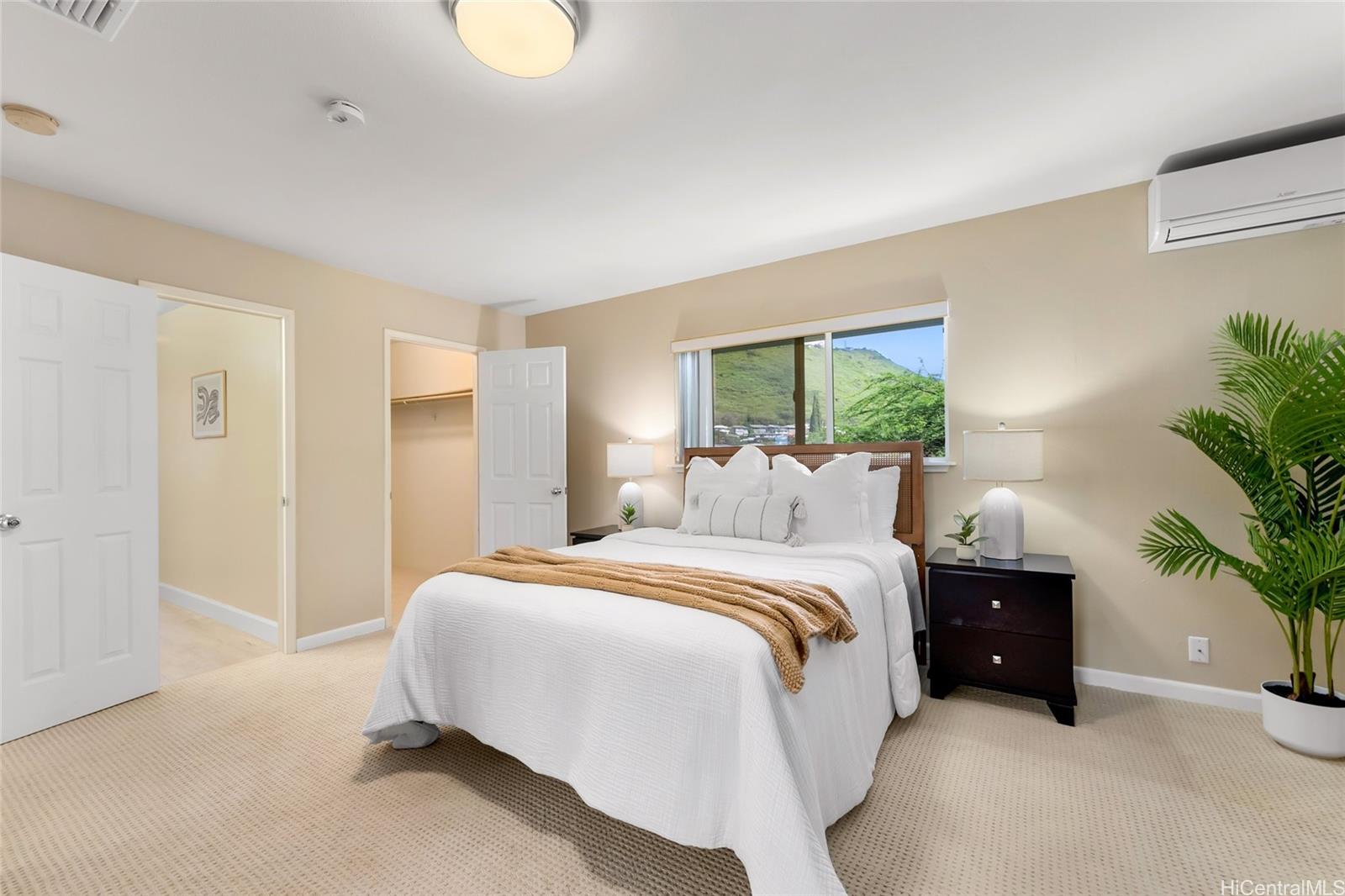 4562 Malia Street Honolulu, HI 96821 - Photo 14 of 25 a bedroom with a bed and a potted plant